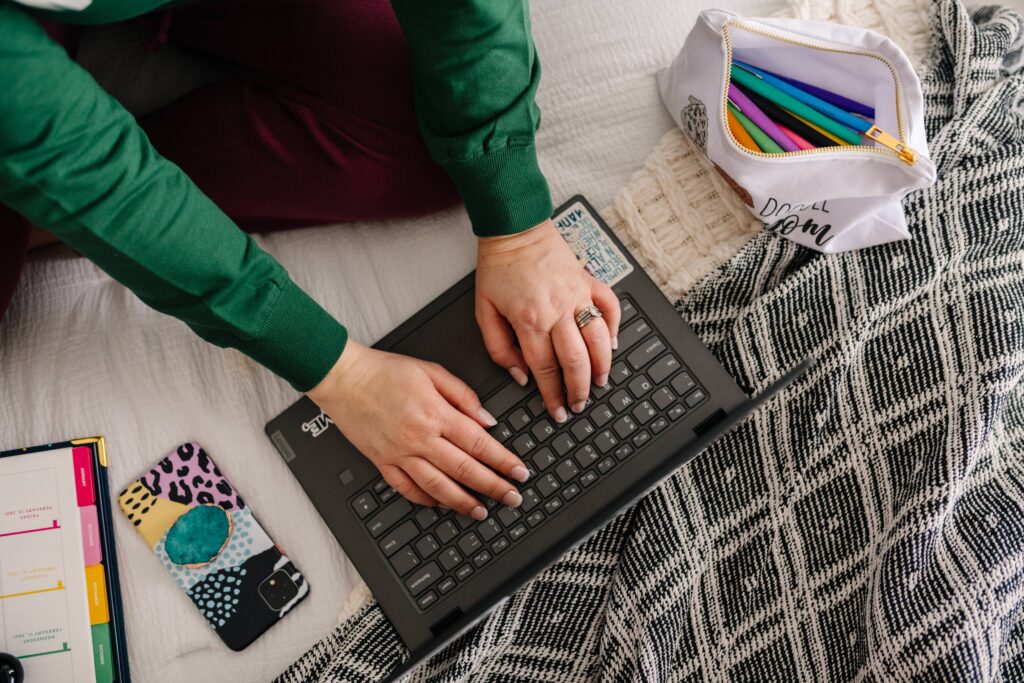 Sara's hands creating website copy for photographers